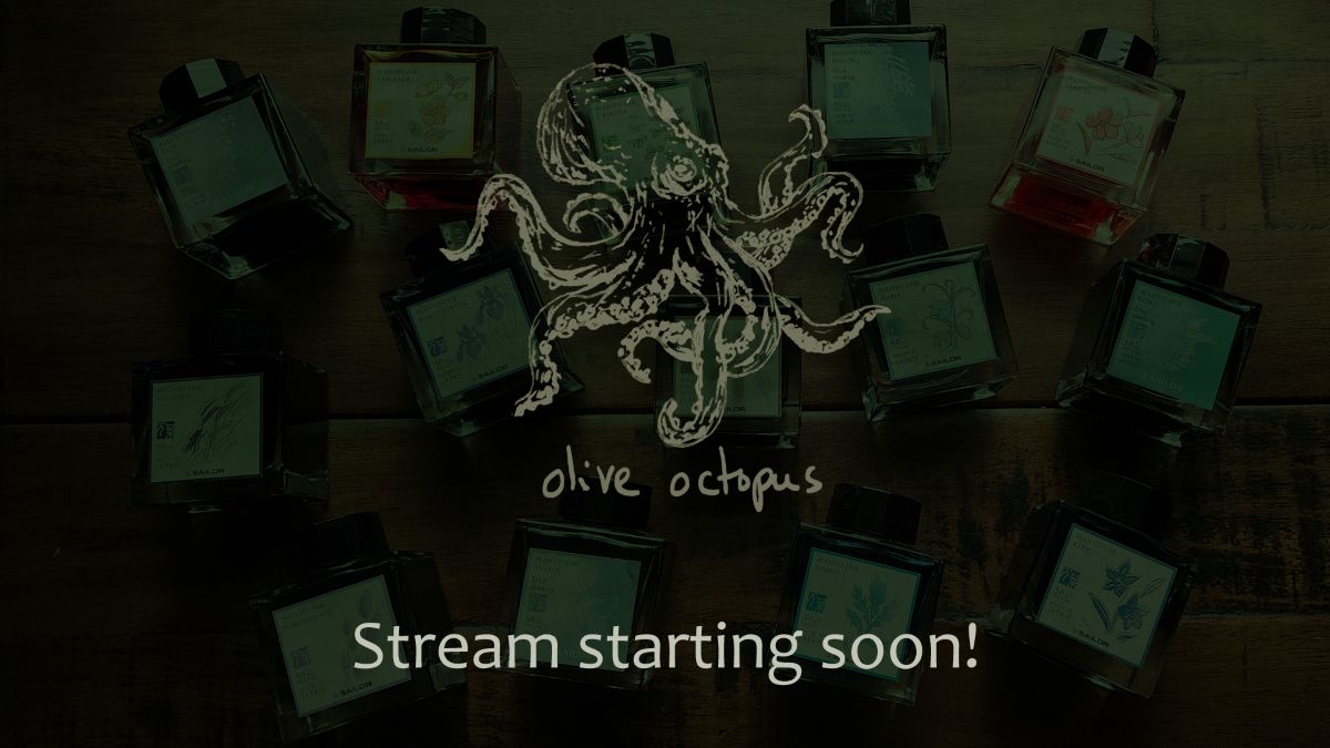 Screenshot of the Stream Starting Soon screen from a Twitch stream with a sketch of an octopus and the words'olive octopus' over a darkened image of fountain pen ink bottles on a desk.