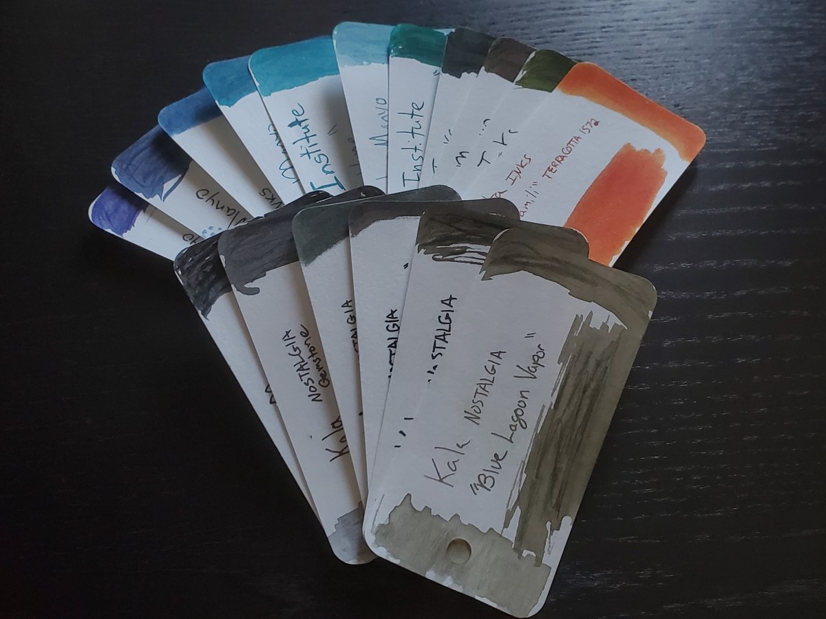 Set of Col-o-ring ink swatches in shades of gray, orange, green, and blue.