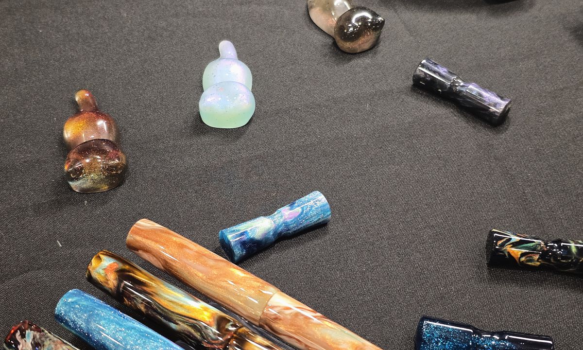 Closeup of resin pen rests in the shape of cats and resin pen rest/ink swatching tools.