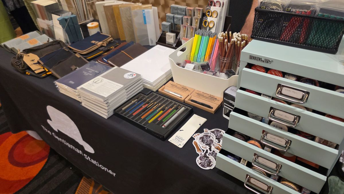 The Gentleman Stationer's table with small filing drawers full of washi, wood case pencils, notebooks, Lochby covers, Laurett's pens, Traveler's notebooks, Ro-biki notebooks, etc.