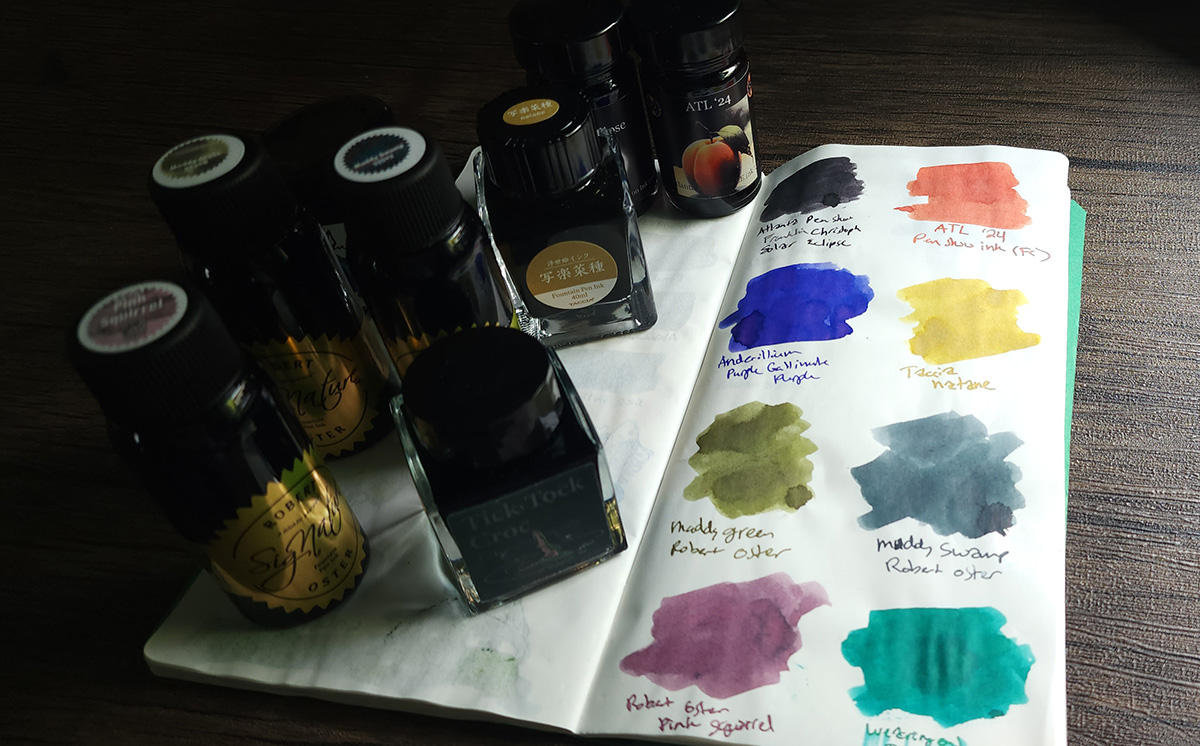 Colorful ink swatches and bottles for eight inks including three Robert Oster inks, a Wearingeul ink, a Taccia ink, and the two Franklin-Christoph show inks.