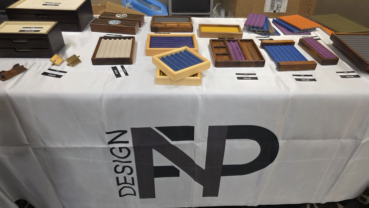 The NFP Design table at the show with wooden pen boxes and pen storage trays.