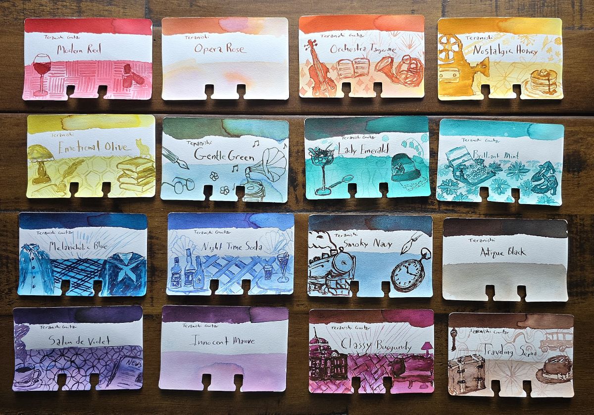 Sixteen Col-o-dex cards representing the entire line of Teranishi Guitar inks are laid out in a grid, most with sketches of objects and patterns found on the ink boxes and three cards without sketches.