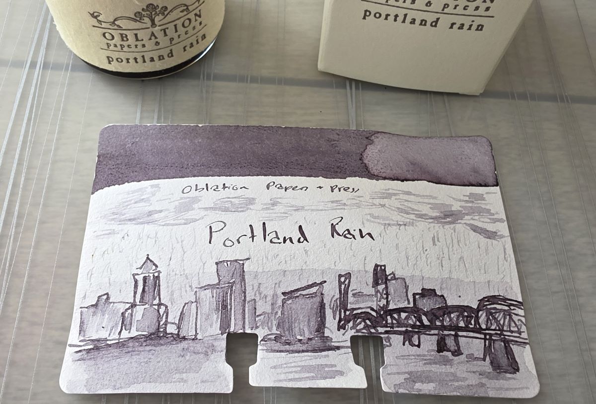A close up of the finished sketch with Oblation Portland Rain ink showing the Portland skyline and bridge on a rainy day.
