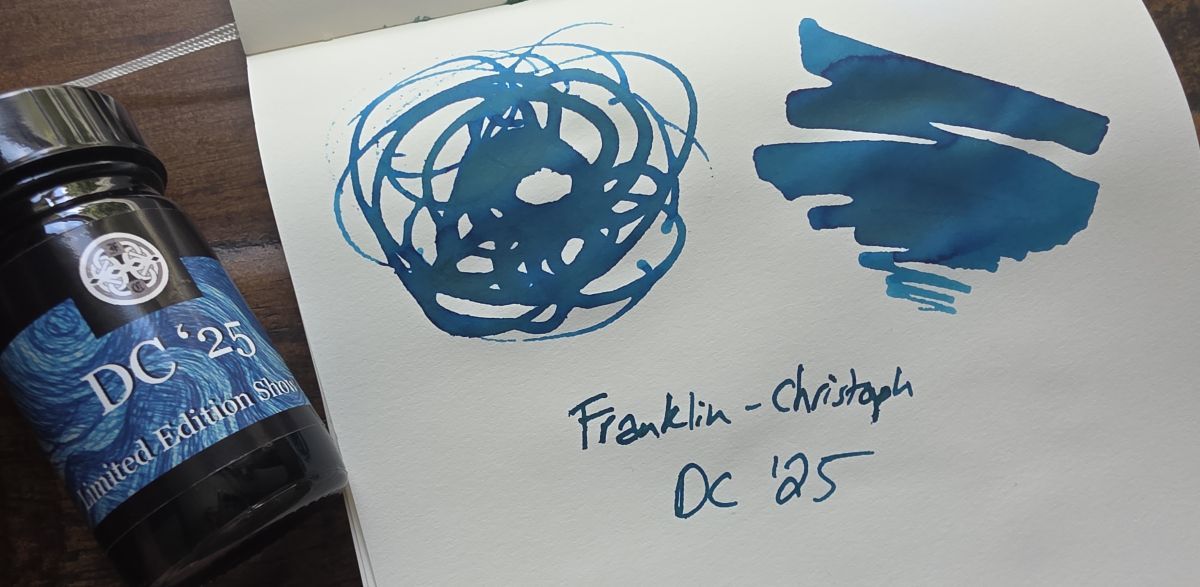 Bottle of Franklin-Christoph DC '25 Limited Edition Show fountain pen ink and swatch of the blue green chromashading ink on Midori cotton paper.
