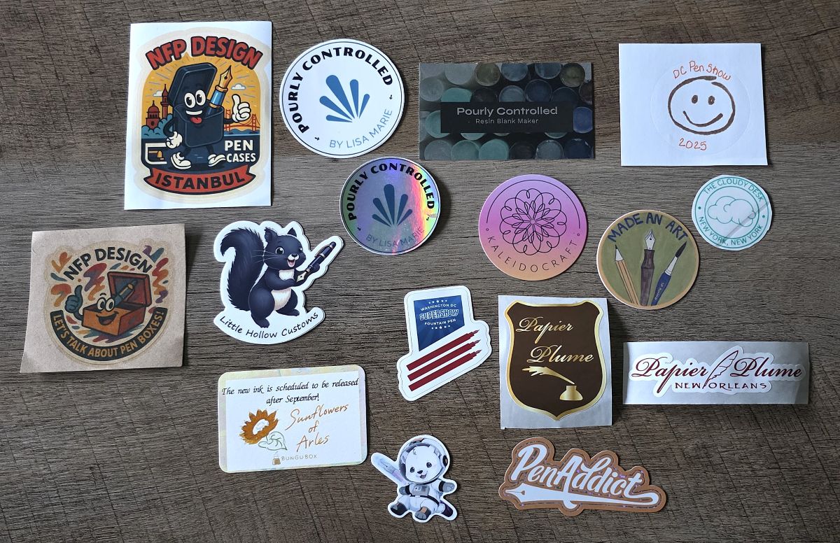 Collection of stickers and cards from NFP Design, Little Hollow Customs, Pourly Controlled, Kaleidocraft, The Cloudy Desk, Papier Plume, Pen Addict, White Bear Pens, Bungubox, and the Washington DC Supershow.