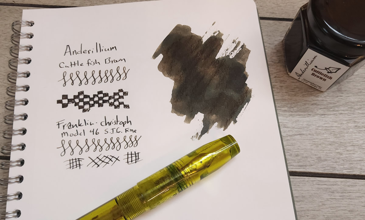 A notebook page with writing sample and ink swatch for Anderillium Cuttlefish Brown, with a Franklin-Christoph Model 46 Olivae pen.