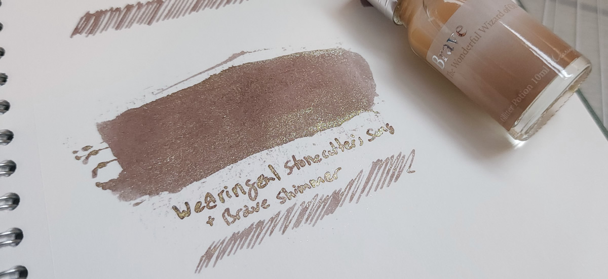 A swatch in a notebook of the warm taupe brown of Wearingeul Stonecutter's Song mixed with the silver and gold Brave shimmer potion, and the bottle of Brave shimmer additive.
