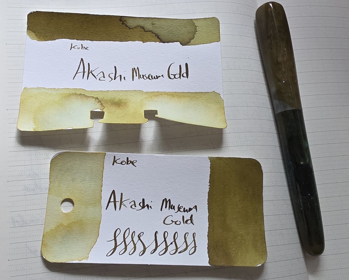 A Col-o-ring and Col-o-dex card for Kobe Akashi Museum Gold, a dark yellow green that looks like burnished gold, and a hand-carved fountain pen with matching gold and green shades.