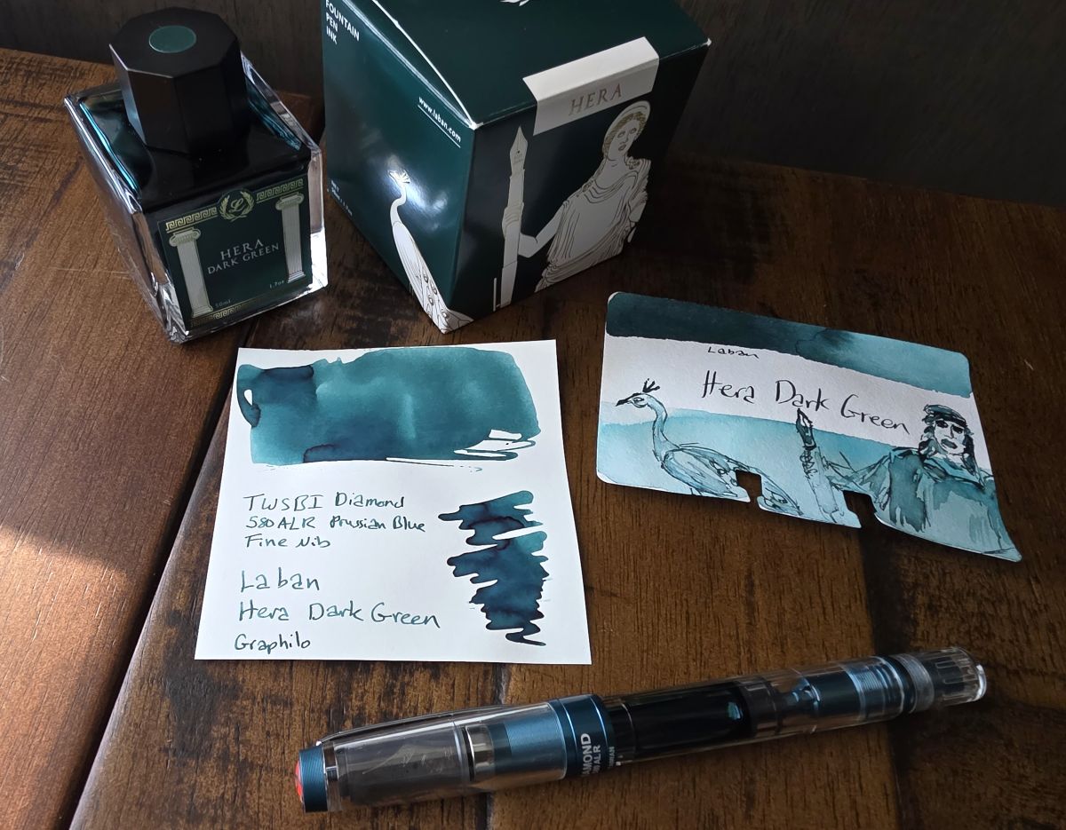A paper swatch and Col-o-dex ink swatch card with a sketch of the box art for Laban Hera Dark Green, a blue-leaning teal.