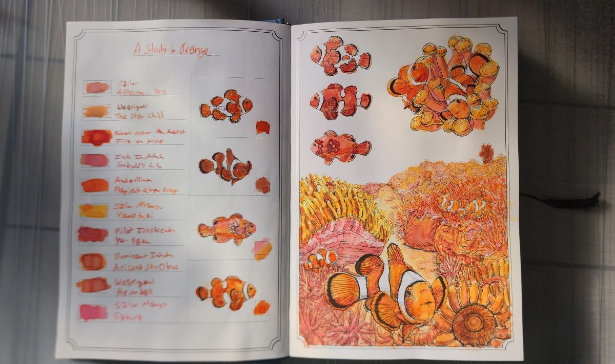 A hardcover book opened to a page of clownfish and anemone drawings brightly painted in ten different shades of orange.