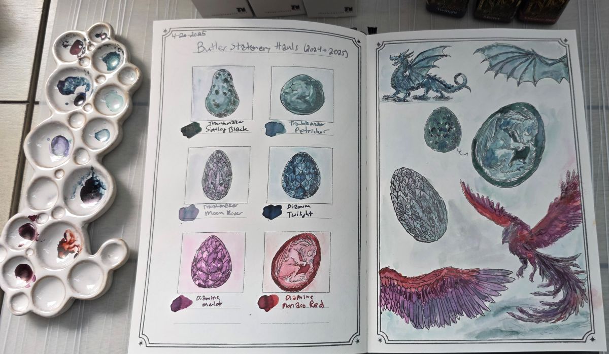 Dominant Industry Ink Archiving Book, A Log of Elixir, open to a page featuring dragons, phoenixes, and ornate eggs painted with fountain pen inks in blues, greens, red, pink, and purple. Troublemaker inks: Sinulog Black, Petrichor, and Moon River, and Diamine inks: Twilight, Merlot, and Monaco Red.