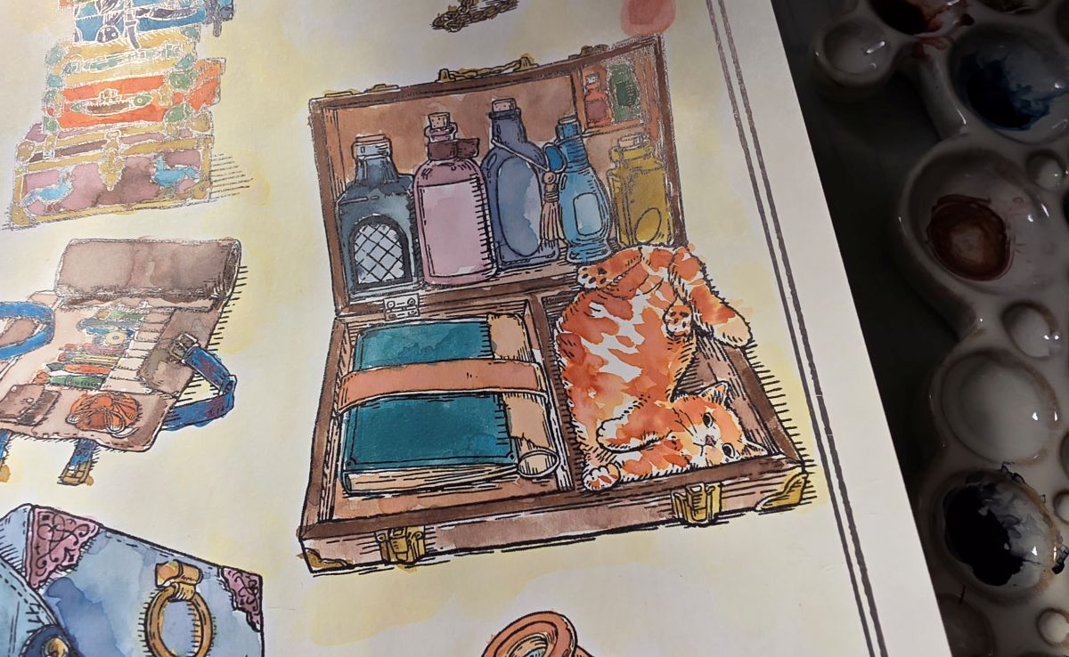 Close up of a painted page in the Ink Archiving Book showing an open suitcase with glass bottles in multiple colors lined up in the lid, a book strapped on the left side of the bottom section, and an upside-down striped orange cat playing on the right side.