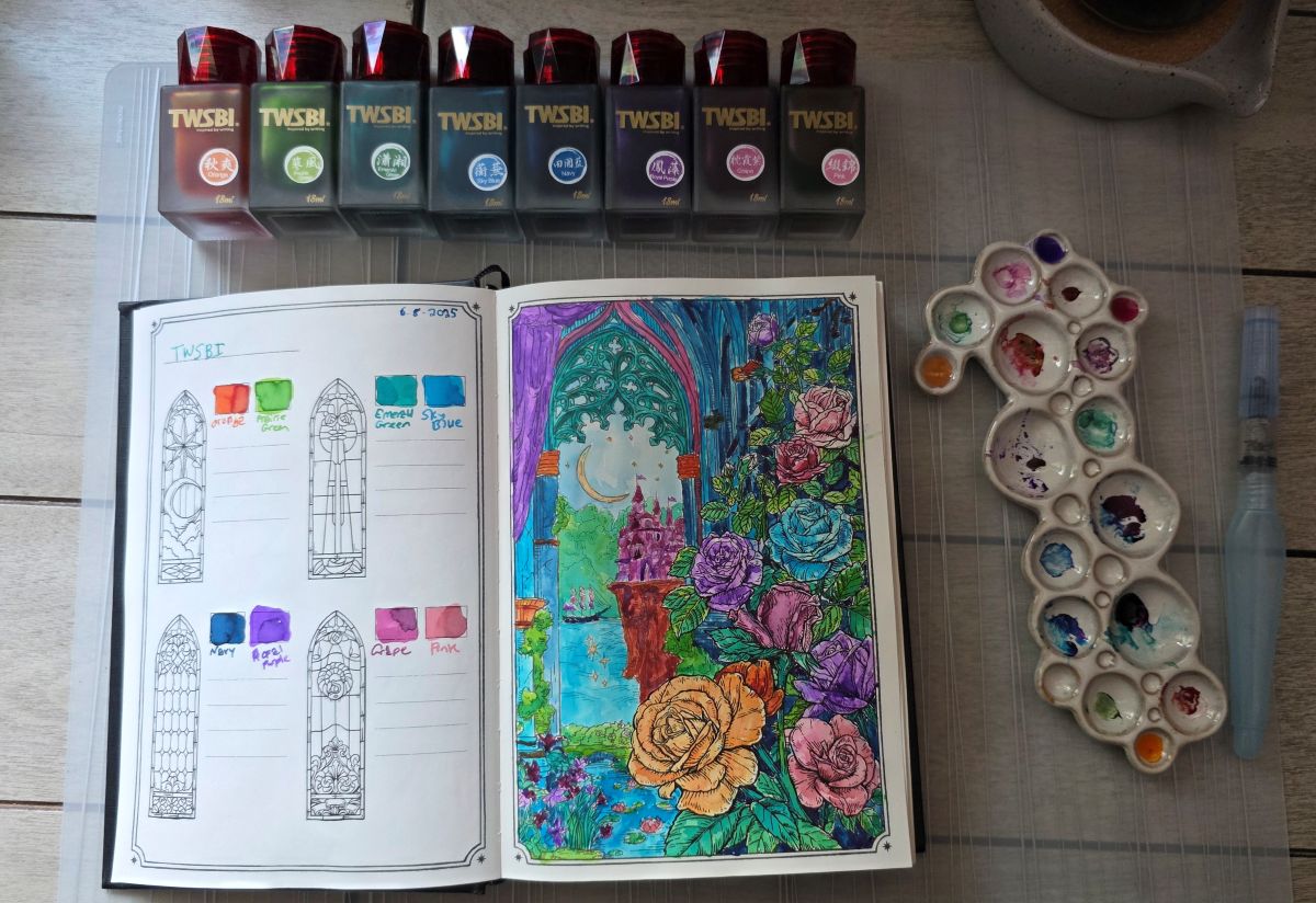 Eight 18ml frosted glass bottles with TWSBI inks Orange, Prairie Green, Emerald Green, Sky Blue, Navy, Royal Purple, Grape, and Pink. Dominant Industry Ink Archiving Book, Log of Elixir, open to page with design of roses climbing up a wall and a window looking out to a castle on a cliff, a ship, and the sky filled with a crescent moon and stars, all painted with those 8 inks, and a ceramic paint palette that looks like bubbles with colorful inks in the wells.