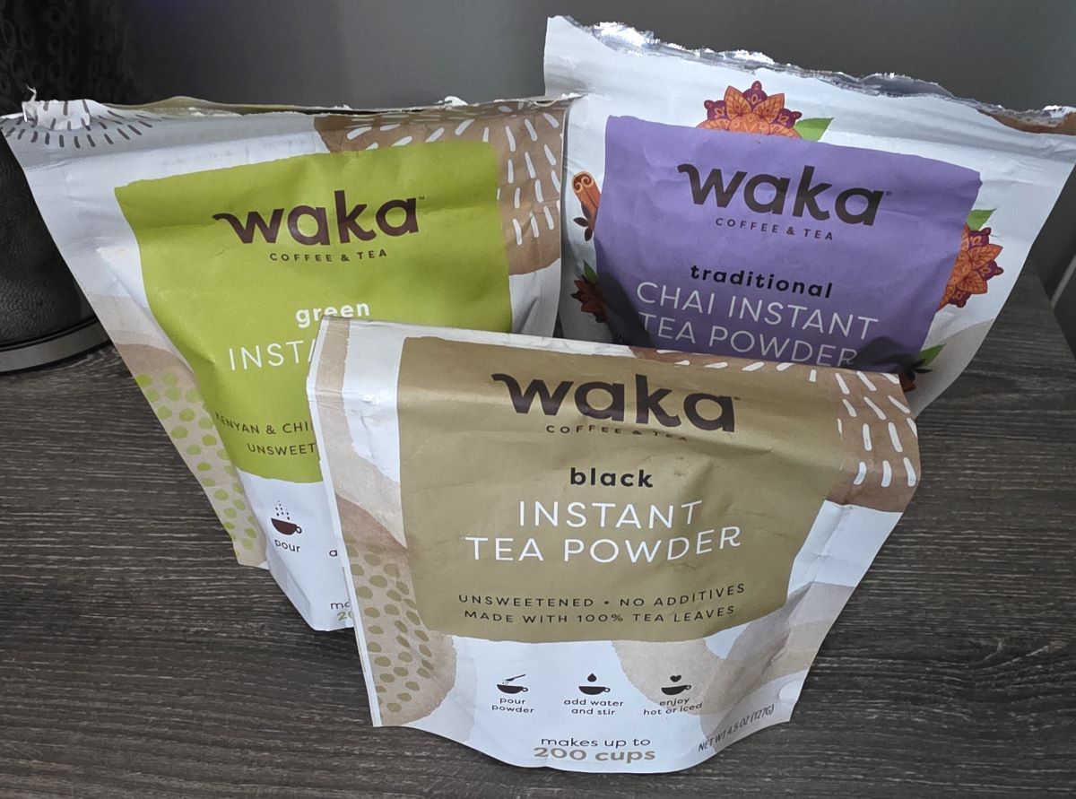 Three pouches of instant tea powder from Waka in black tea, green tea, and chai varieties.