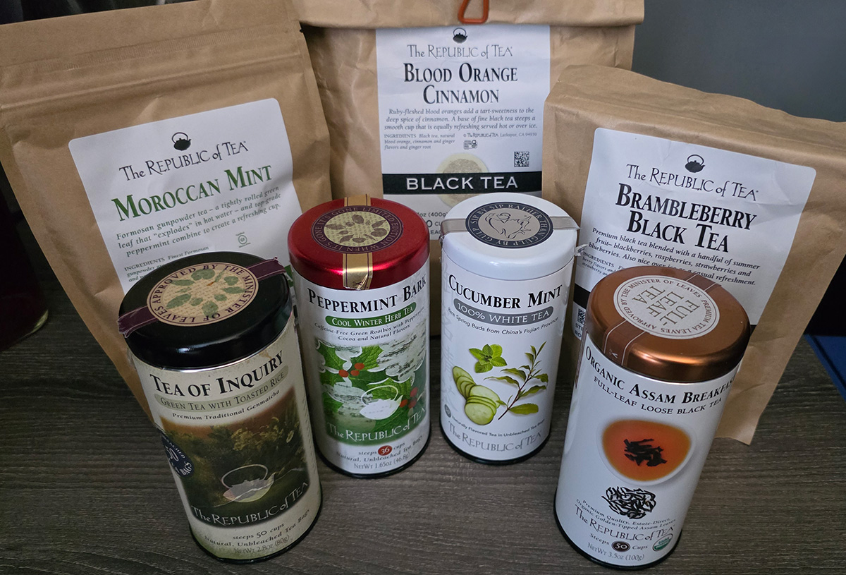 Several bags and tins of tea from The Republic of Tea. Flavors include Moroccan Mint loose leaf, Blood Orange Cinnamon black tea, Brambleberry Black Tea, Tea of Inquiry green tea with toasted rice, Peppermint Bark Rooibos, Cucumber Mint White Tea, Organic Assam Black full-leaf loose tea.