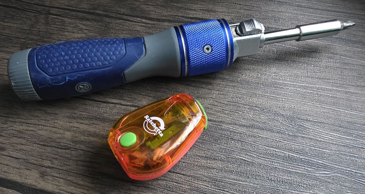 A manual screwdriver with a switch to control a ratcheting mechanism, and a small, hand-held ratcheting pencil sharpener.