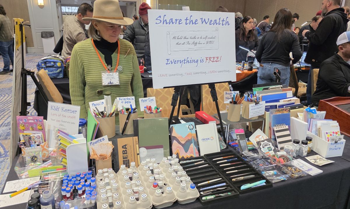 The Share The Wealth table with extra/unneeded items available for free, with a variety of kid-friendly items along the side, ink samples, standard and fountain pens, notebooks, stickers, and much more.