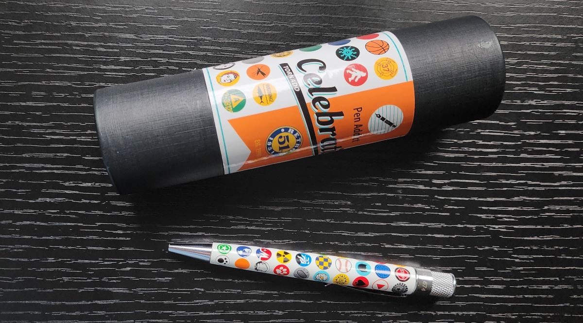 Celebration Retro 51 pen and tube, white background with round finial designs of dozens of past Retro 51 pens.