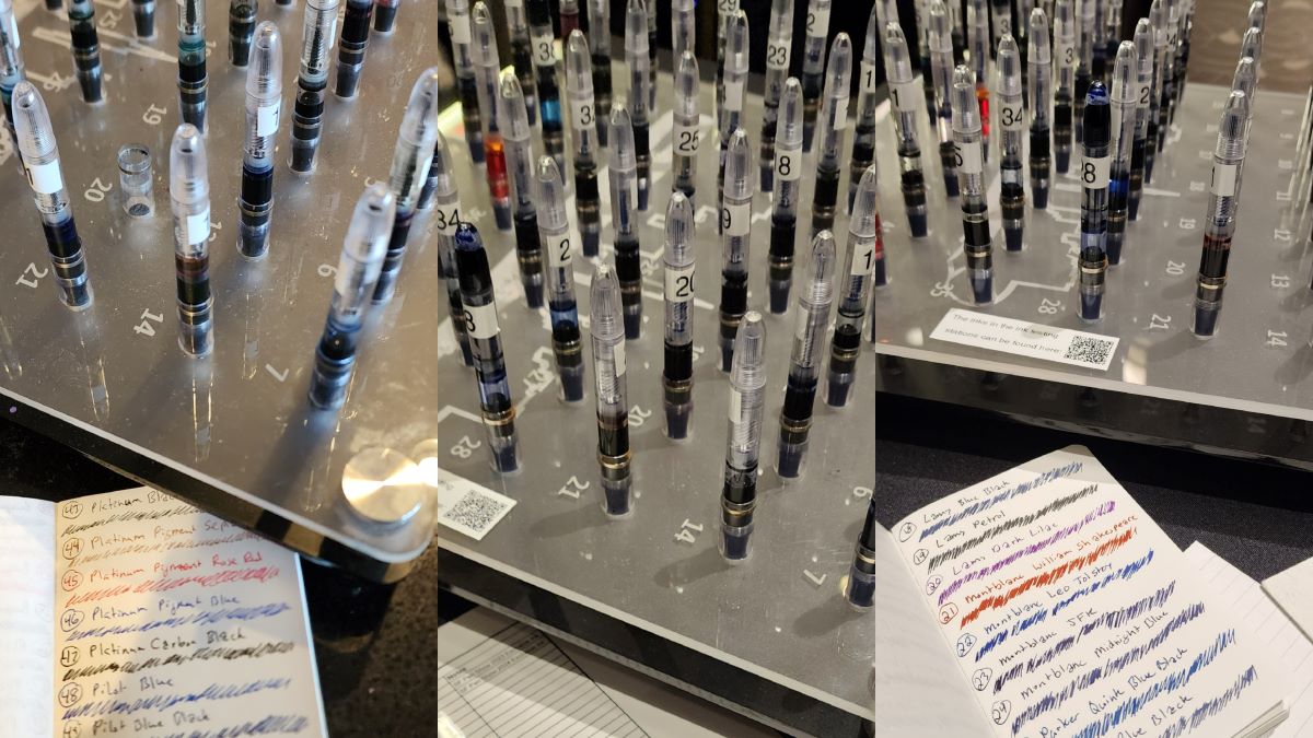 Plexiglass racks of test fountain pens filled with different inks, notebook of ink names and scribbles in each ink color.