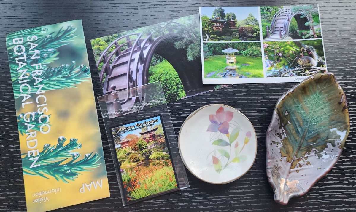 Map from Botanical garden, postcards and magnet from Japanese Tea Garden, small porcelain dish with painted flowers, small glazed leaf dish