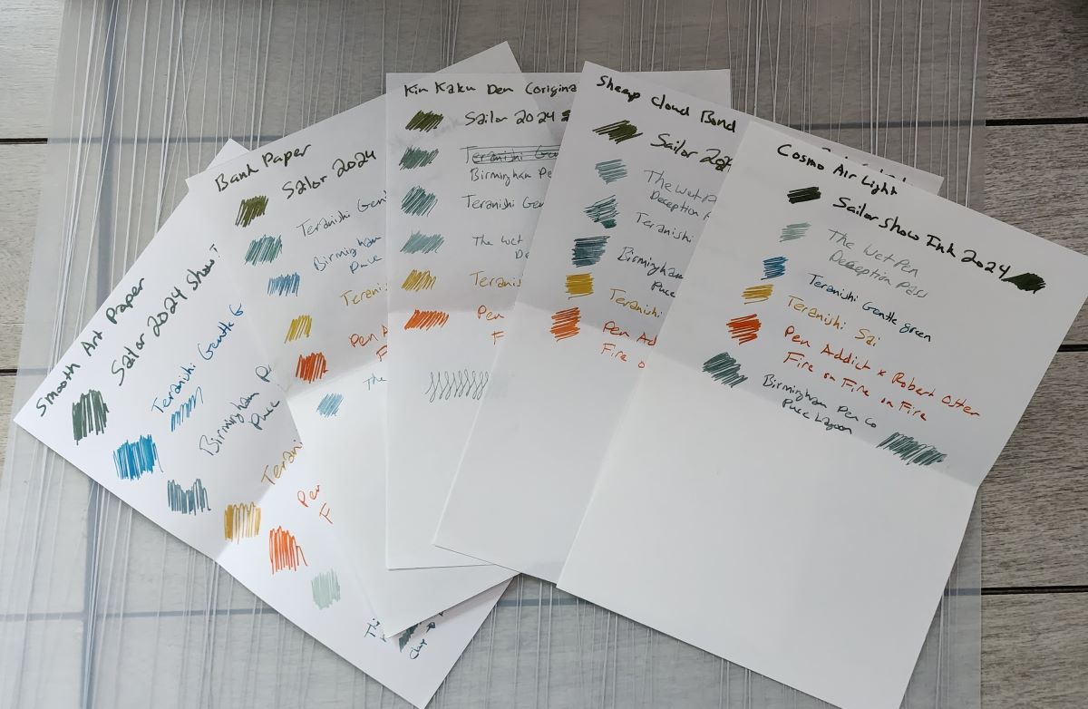 Five A5 sheets of paper with test writing in multiple colors of ink