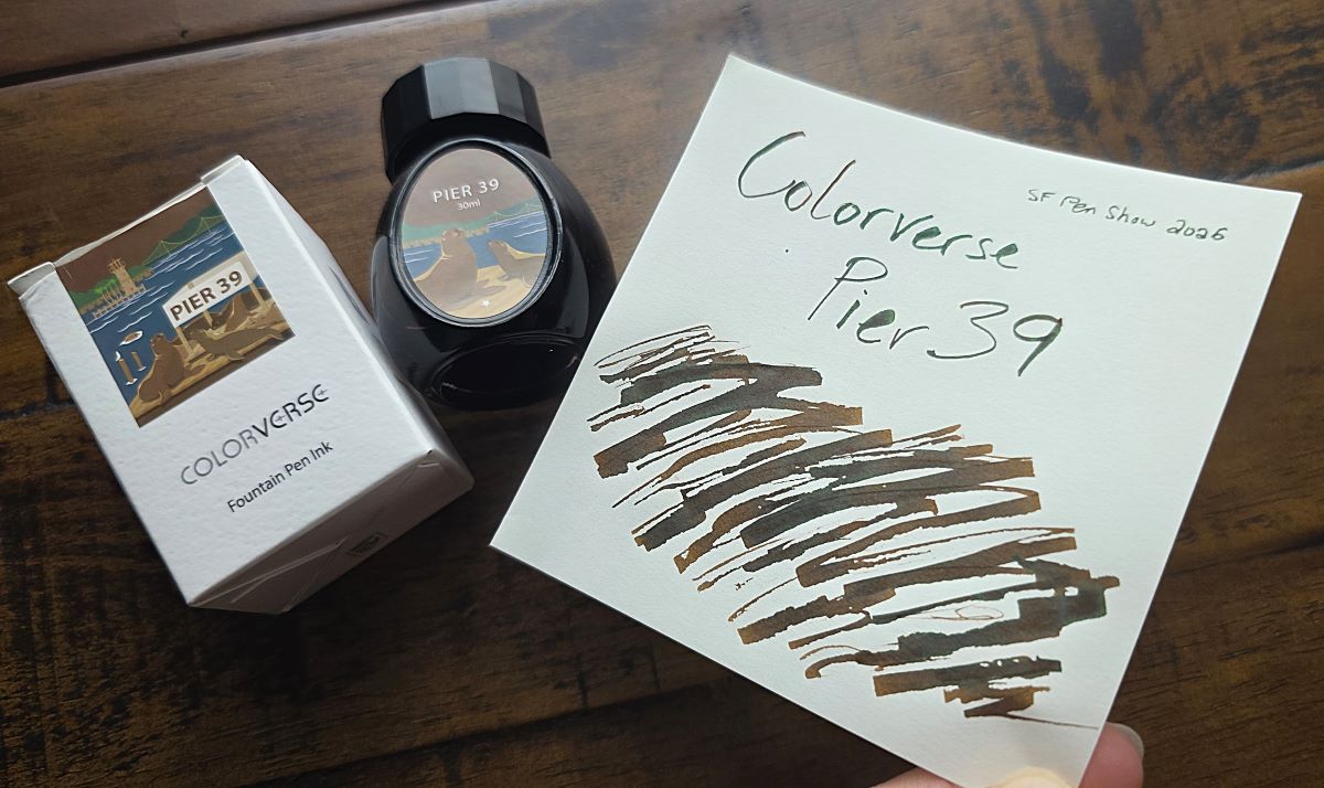 Bottle and swatch of Colorverse PIER 39 ink, a dark brown with some green sheen.