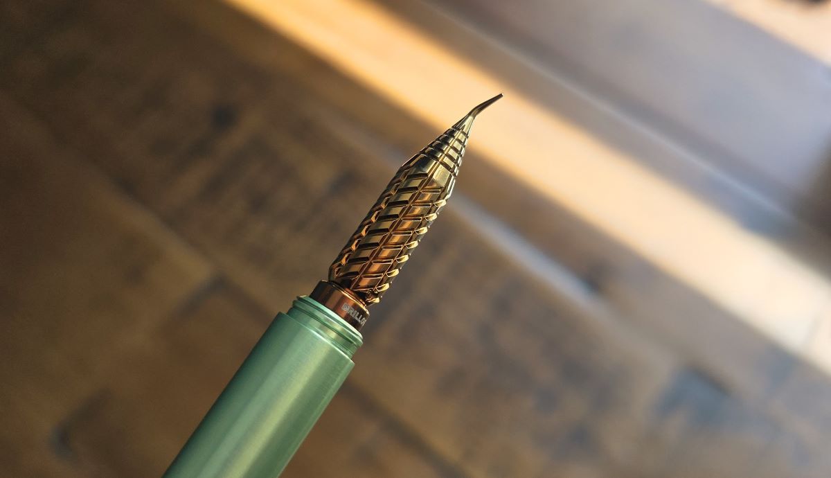 Closeup of yellow and brown fude Drillog metal dip nib.