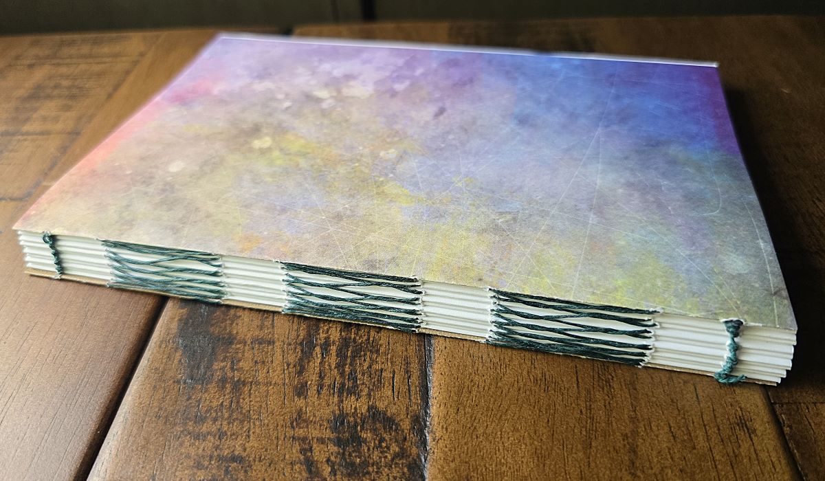 Closeup of French Link Stitch binding in a 10 signature (plus covers) handmade notebook.