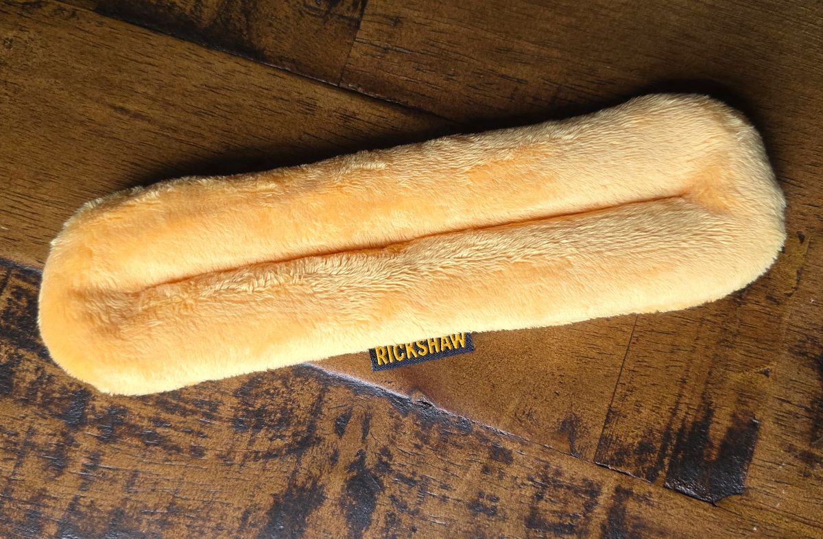 A plush pen pillow pen rest from Rickshaw in golden yellow.