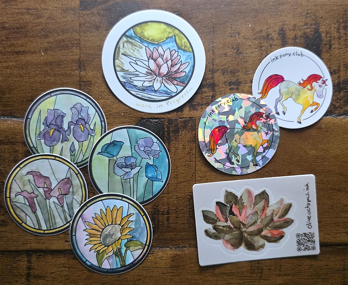 Several vinyl stickers with painted floral and pony designs.
