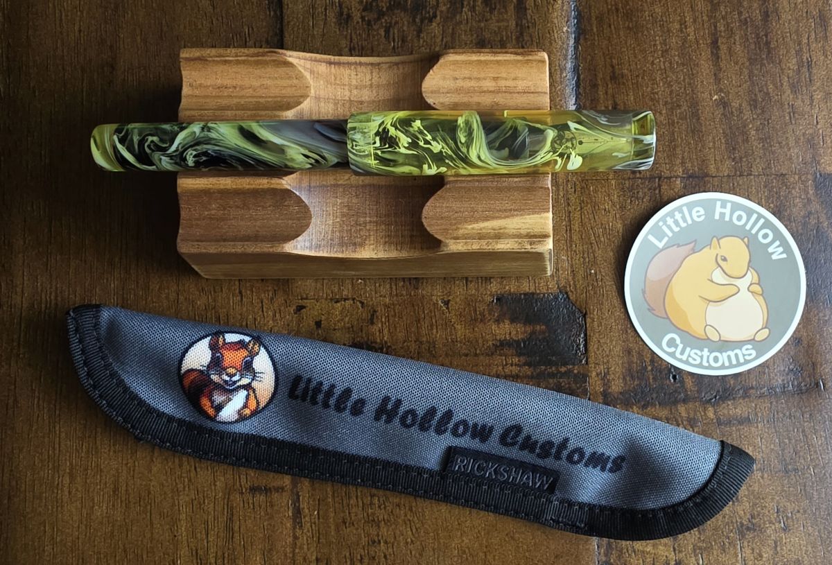 Turned fountain pen in transparent, yellow, and smoke swirled resin from Little Hollow Customs along with custom Rickshaw sleeve and sticker.