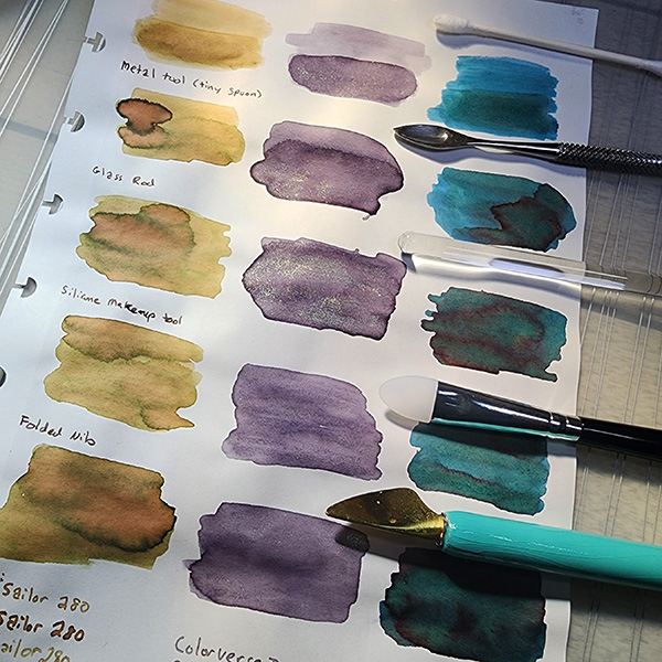 Sheet of paper with ink swatches and a selection of 5 different swatching tools.