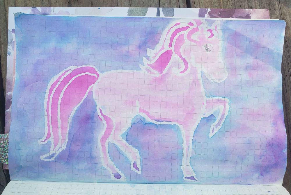 Coloring book outline of pony painted in chromashading pinks and purples and blues.